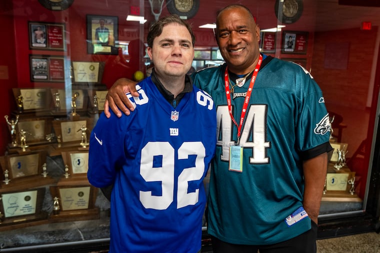 David Siegel, a 2010 graduate of Cherry Hill High School East, with his former teacher, Mike Surrency. The two developed a special bond while supporting rival football teams and began attending games together when the NFC teams played in Philadelphia. It has continued for years and they will be at the Linc Sunday for the second game between the Eagles and Giants.