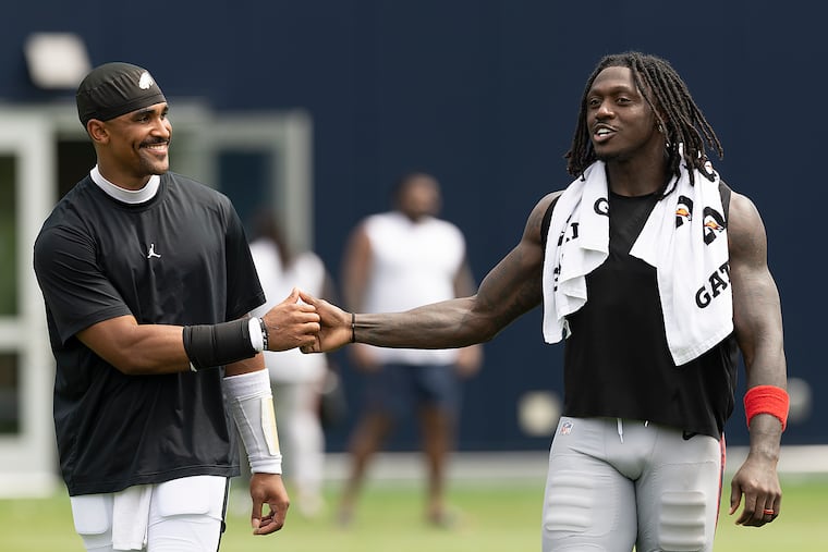 A.J. Brown (right) sought out his former quarterback on the practice field for a cordial reunion.