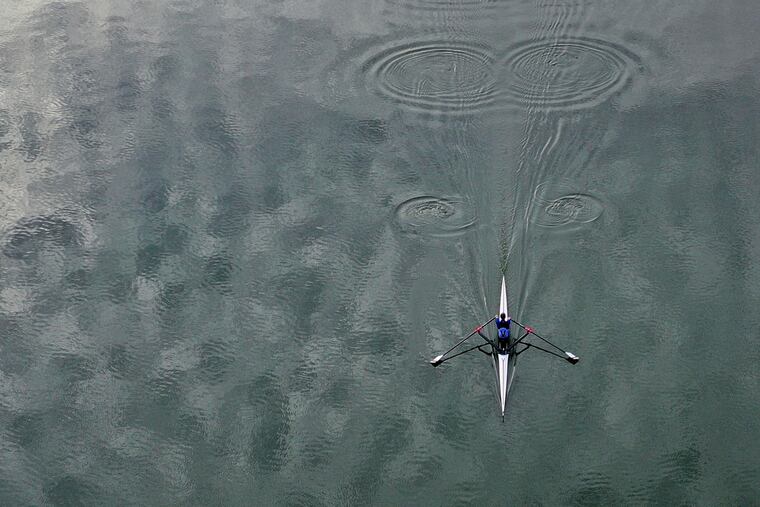 Vesper rower Zach Heese heads upstream in a single scull on the Schuylkill leaving puddles in his wake in mid-forty degree temperatures Thursday December 27, 2018.