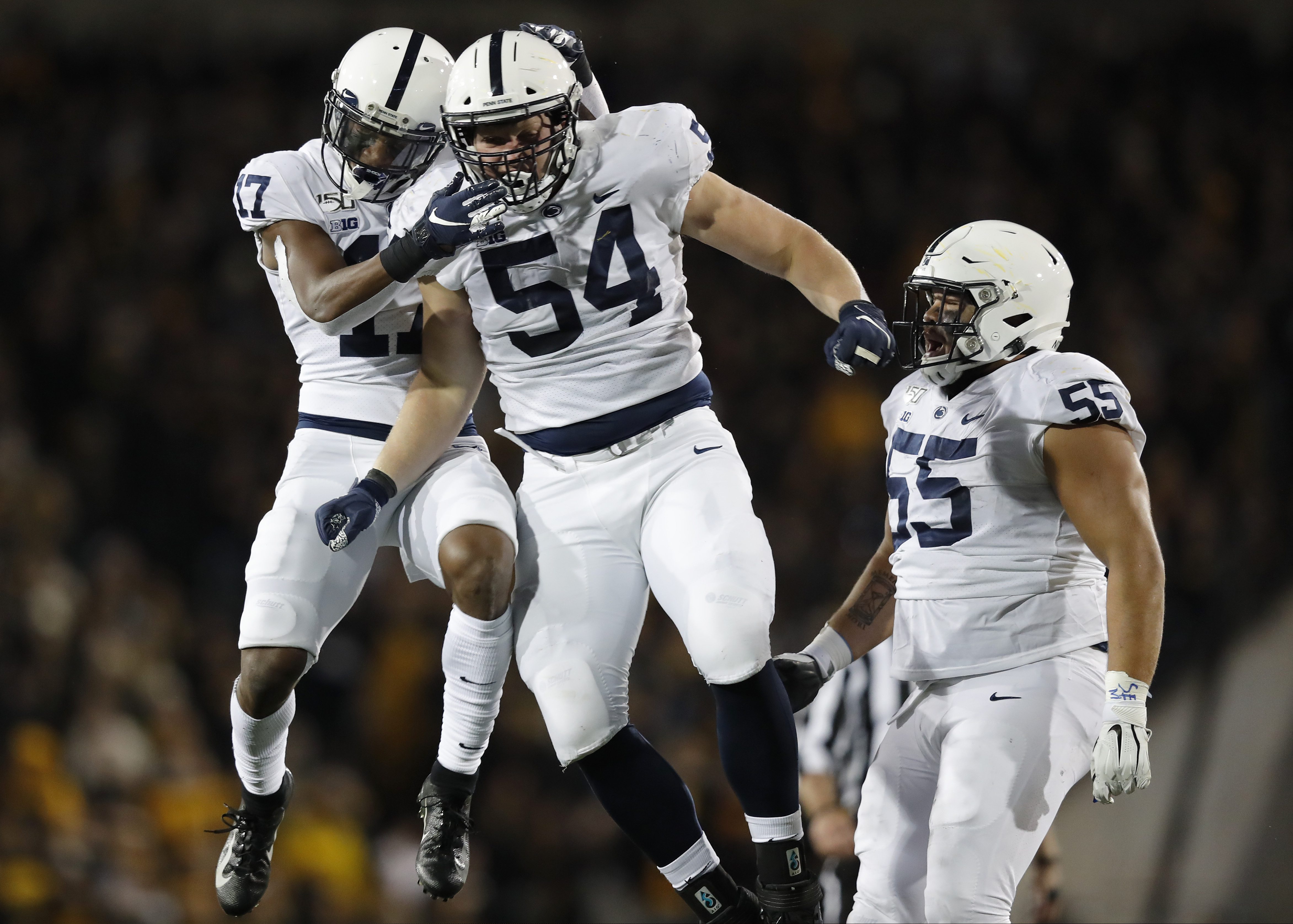 Penn State defensive tackle Robert Windsor (center) celebrates a sack with safety Garrett Taylor (left) and defensive tackle Antonio Shelton against Iowa on Oct. 12, 2019.