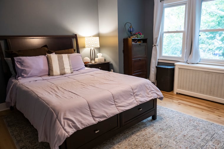 The primary bedroom is currently gray, but she has plans to paint the house soon.