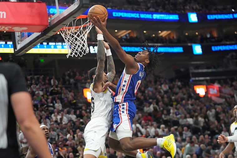 Philadelphia 76ers guard Tyrese Maxey (0) goes to the basket as Utah Jazz forward John Collins, left, defends on Feb. 1, 2024.