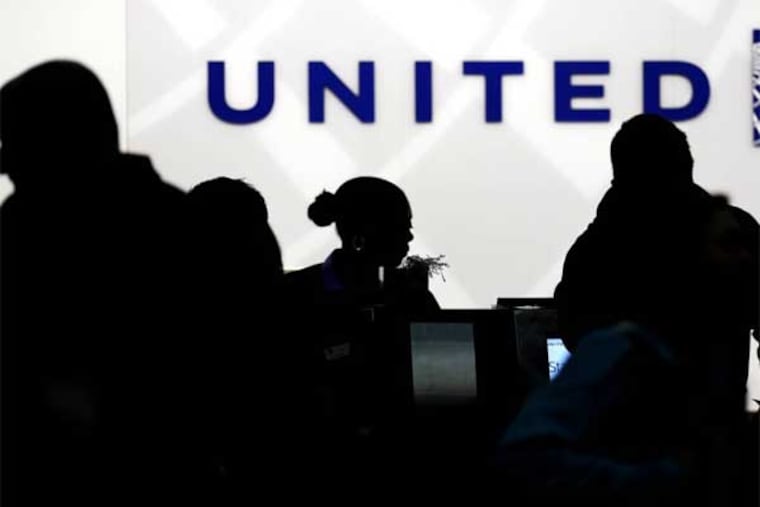 Holiday travelers check in at the United Airlines ticket counter at Terminal 1 in O'Hare International Airport in Chicago on Saturday, Dec. 21, 2013. The National Weather Service issued a hazardous weather outlook for north central Illinois, northeast Illinois and northwest Indiana on Saturday morning. (AP Photo/Nam Y. Huh)