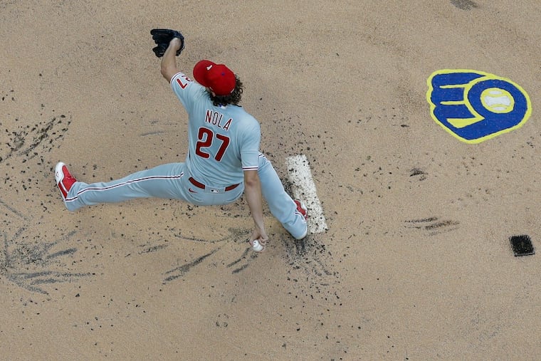 Phillies starter Aaron Nola pitches during the first inning against the Brewers in Milwaukee.