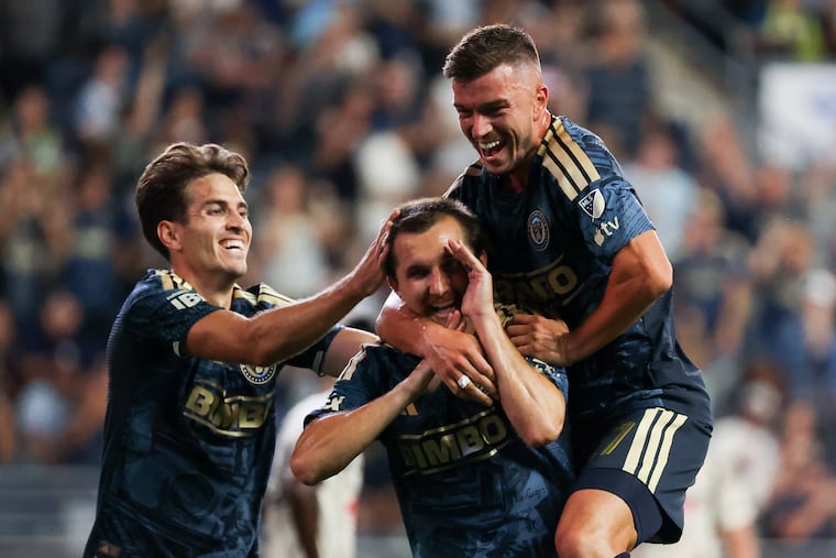Union midfielder Indiana Vassilev (19) celebrates with Kai Wagner (27) and Milan Iloski (10) after Vassilev's second-half goal gave his team a 2-1 lead.