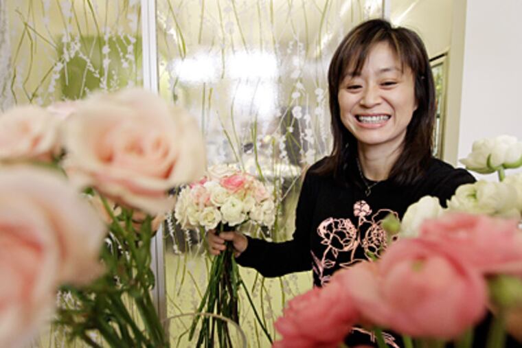 Former veterinarian Kayo Higashimura at her florist shop, Hana & Posy, on North Third Street in Northern Liberties. (Elizabeth Robertson / Staff Photographer)
