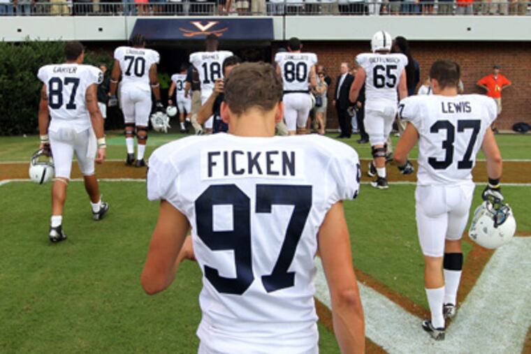 Penn State kicker Sam Ficken walks off the field after missing a field goal in the team's 17-16 loss to Virginia. (Andrew Shurtleff/AP Photo)
