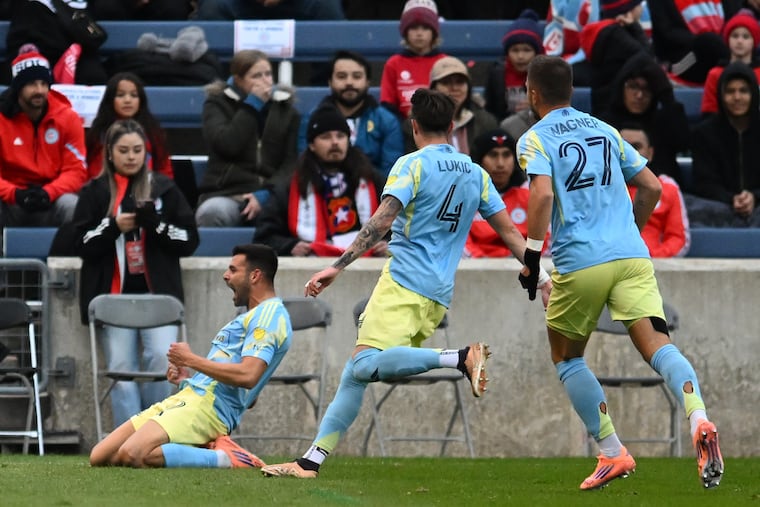 Tai Baribo (left) celebrates with Jovan Lukić (center) and Kai Wagner (right) after one of his two first-half goals against the Fire on Saturday.