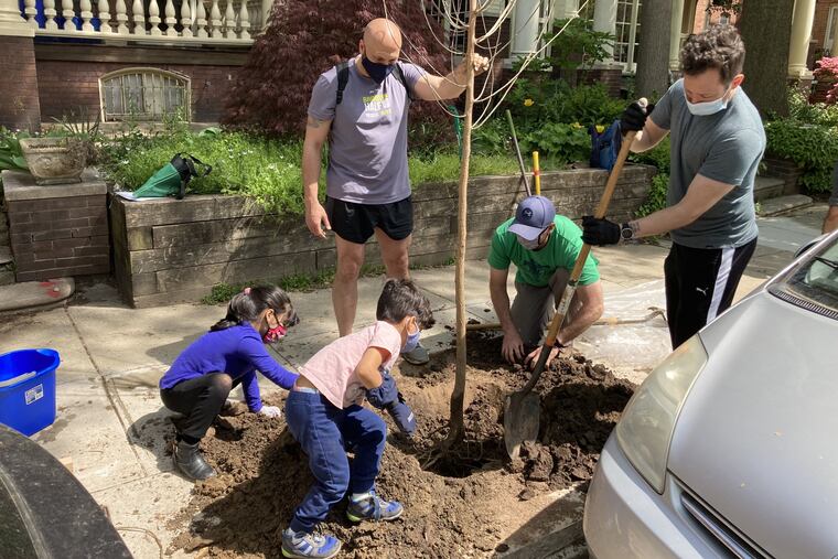 Action Tank volunteers and family members planting trees in the West Philly's Cedar Park neighborhood earlier this summer. Clockwise from top: Organization members Carlos Couto, Matt Connolly, and Jesse Hamilton, with Cuoto's son, Lucio, and daughter, Sabina.