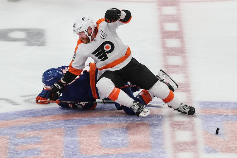 Flyers captain Claude Giroux collides with the Islanders' Zach Parise as the clock runs out during the third period at the UBS Arena in Elmont, N.Y.