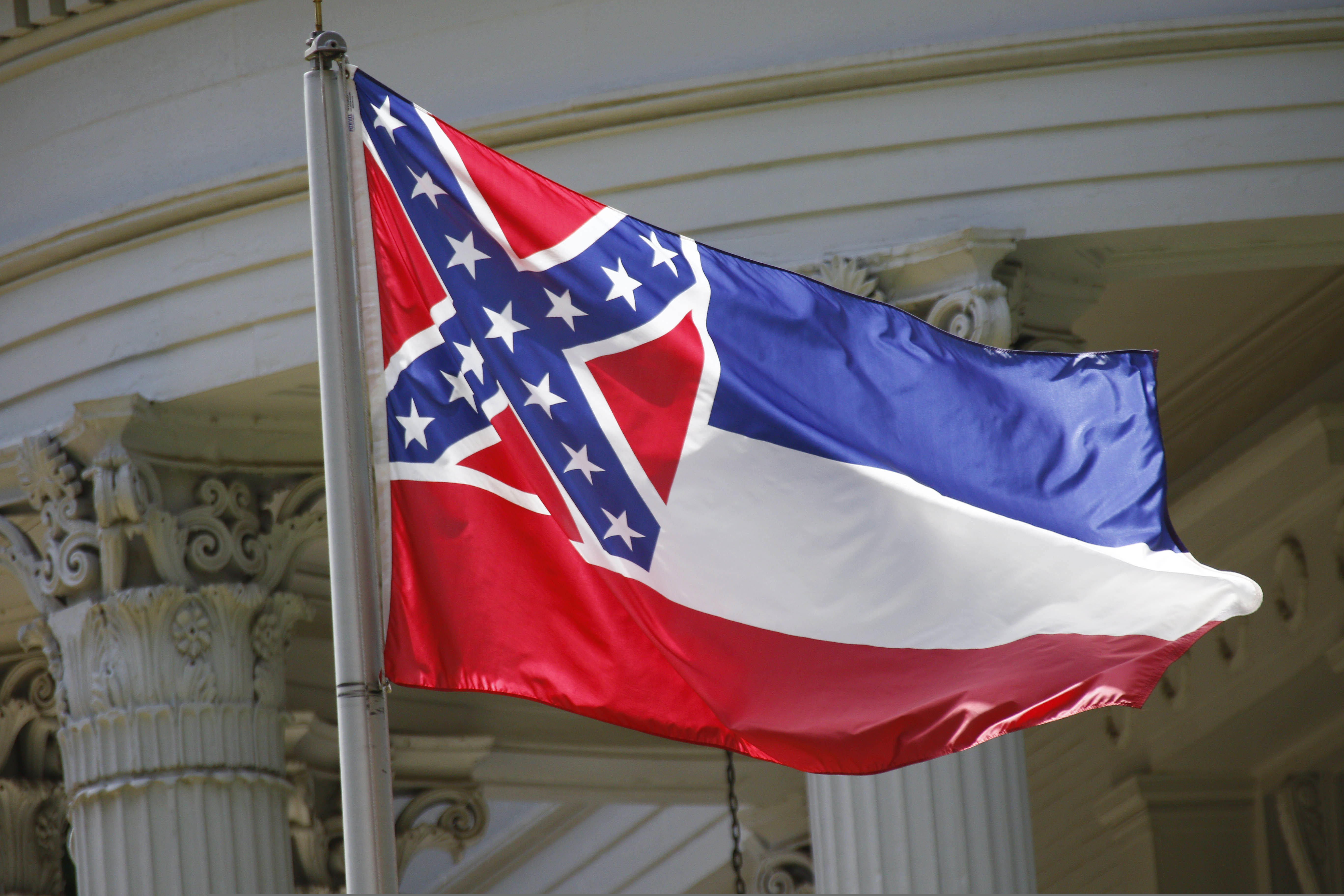 FILE - In this June 23, 2015, file photo, the state flag of Mississippi flies at the Governor's Mansion in Jackson, Miss. New Jersey Gov. Phil Murphy is ordering that the Mississippi flag be replaced by the American flag at a state park that overlooks the Statue of Liberty because it has a Confederate emblem on it.