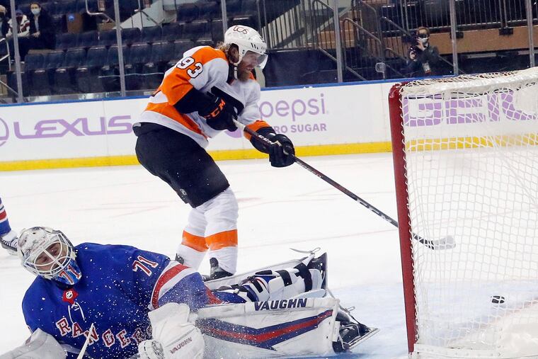 Flyers winger Jake Voracek guides the puck into the net for the overtime-winning goal after getting Rangers goalie Keith Kinkaid to bite on the breakaway move Monday night at Madison Square Garden.