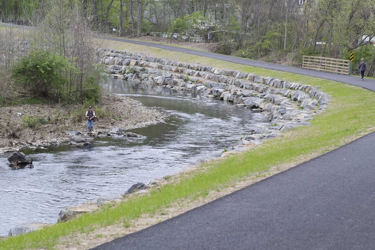 Bob Wargo spin casts for trout beside Delaware County's $6.5M, 2.8-mile Chester Creek Trail, the 20-year dream of the late Mark Fusco from Aston, who wanted everyone to experience his profound love of nature.
