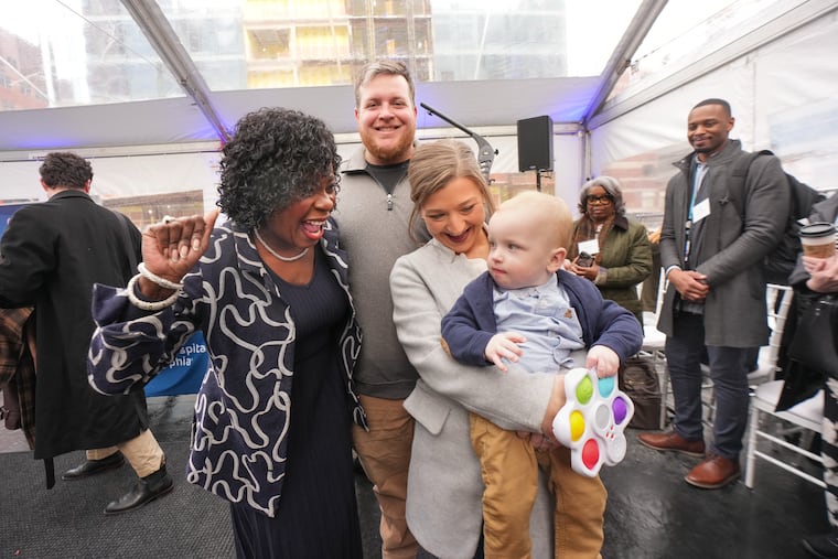 Mayor Cherelle Parker talks with Kyle and Nicole Muldoon and their young son KJ at a press conference at CHOP.