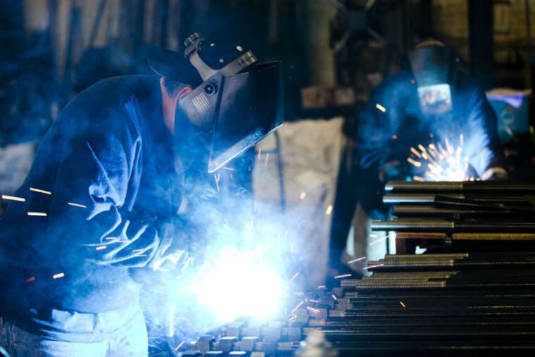 Welders fabricate bolts at Fox Co. Inc. in Philadelphia. The Federal Reserve Bank of Phila. says that manufacturing in the region is growing at its fastest pace in three years. (AP Photo)