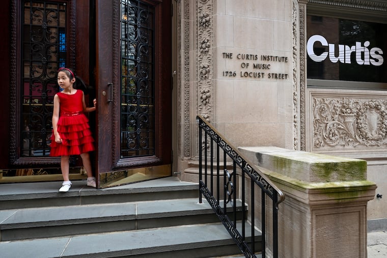 Seven-year-old pianist Olivia Li at the entrance to the Curtis Institute of Music.
