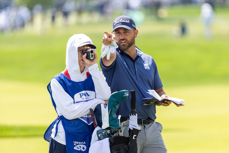 Braden Shattuck chats with his caddie Beau Rivière, 18, on the 16th hole at the PGA Championship at Aronimink Golf Club on Thursday.