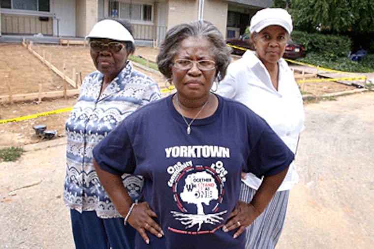 Mary McCrea, left, Renee McNear, center, and Constance Taylor, right, in their Yorktown neighborhood, where the owner of the
house behind them is trying to put in a four-person driveway. (Jessica Griffin / Philadelphia Daily)