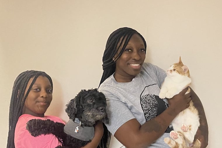 Carina Cheatham (right), a.k.a. Nina Love, founder of The Black Thornberry animal rescue, with her daughter Arianna (left) and their pets they rescued as strays, Milo the cat and Stitch the poodle.