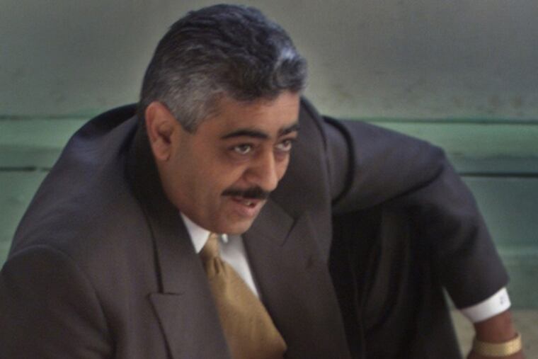 Sam Kuttab posing in a North Broad Street office. (John Costello photo)