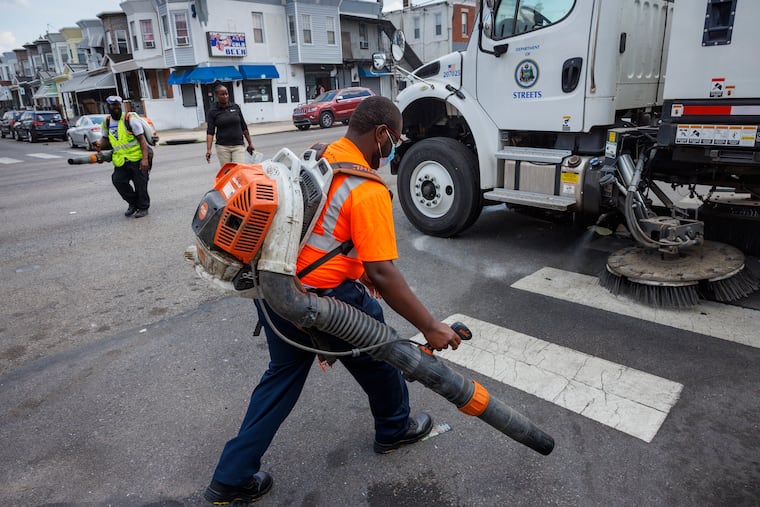 Workers clean the street in June as part of Mayor Cherelle L. Parker's initiative to spruce up the city.