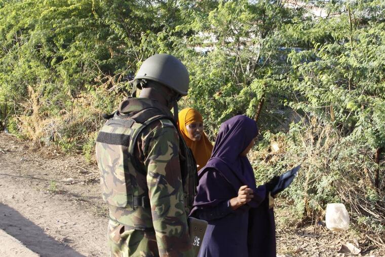 A Kenya Defence Forces soldier secures the area of the Garissa University college, in Garissa, Kenya, Thursday, April 2, 2015. Al-Shabab gunmen attacked Garissa University College in northeast Kenya early Thursday, targeting Christians and killing over 100 people and wounding others, according to Kenya's national disaster operations center and the interior minister. (AP Photo/Khalil Senosi)