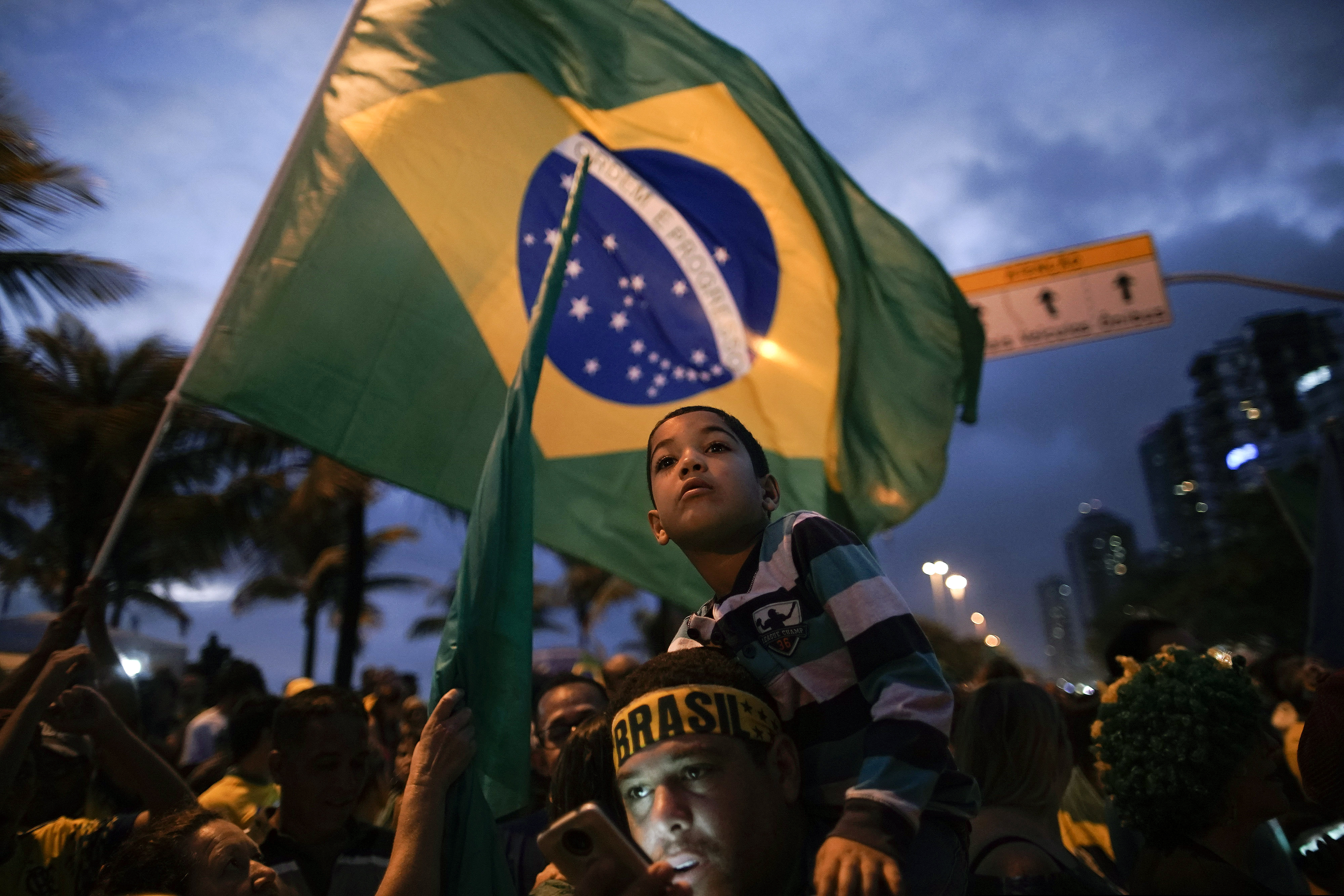 Supporters gather outside the residence of presidential candidate Jair Bolsonaro in anticipation of his victory speech, in Rio de Janeiro, Brazil, Sunday, Oct. 28, 2018. Brazil's Supreme Electoral Tribunal declared the far-right congressman the next president of Latin America's biggest country. (AP Photo/Leo Correa)