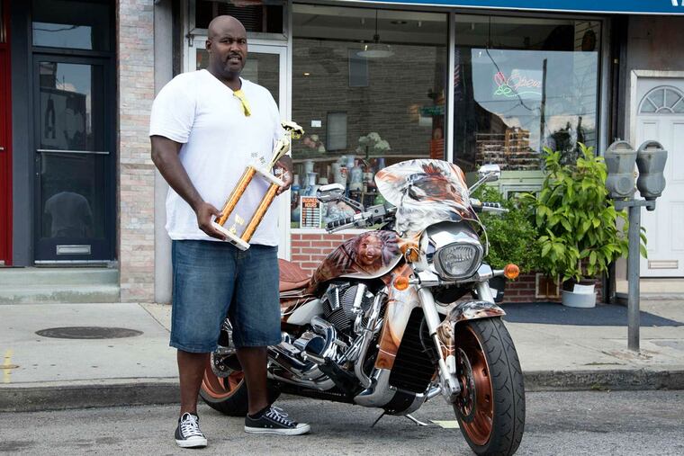 Nate Gibson shows off his motorcycle and its award-winning paint job on Sunday.