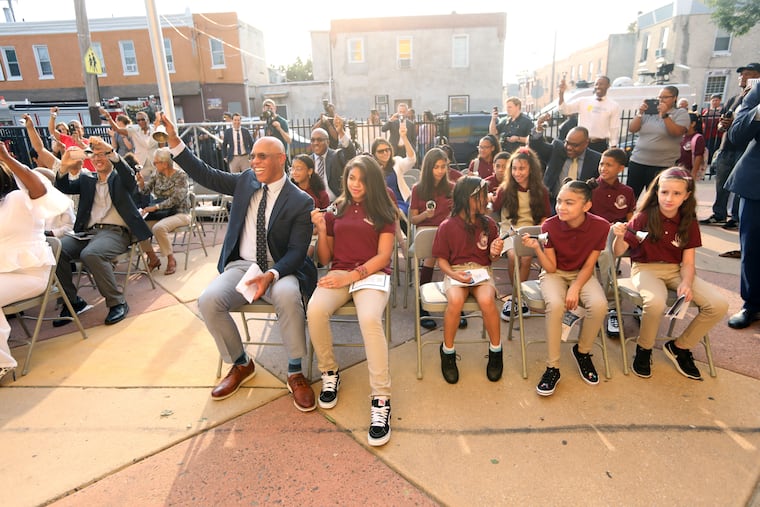 Dr. William R. Hite, Superintendent for the School District of Philadelphia helps ring in the new year on the first day of school with (L-R) Angelys Roman, Jarhaim Munoz, Marianna Rodriguez, and Annika Pfeister at the Luis Munoz-Marin School in Philadelphia, Pa., Aug. 27, 2018.