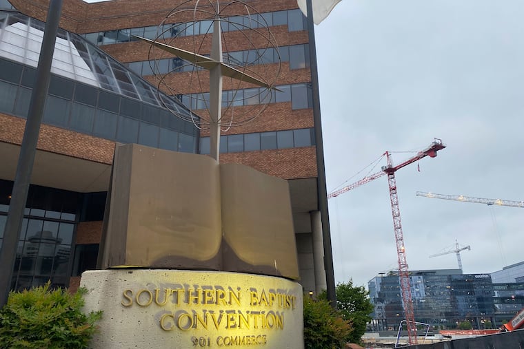 A cross and Bible sculpture stand sculpture outside the Southern Baptist Convention headquarters in Nashville, Tenn., on Tuesday.