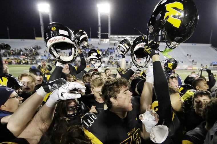 Archbishop Wood players celebrate after beating Gateway, 49-14, for the PIAA Class 5A football championship.