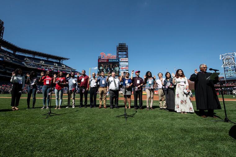 U.S. District Judge Juan R. Sánchez conducts a naturalization ceremony at Citizens Bank Park before the Phillies Sunday, September 15, 2019.