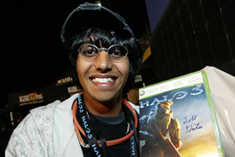 Ritesh David, 17, of Bellevue, Wash., shows off his copy of Halo 3
autographed by Microsoft Chairman Bill Gates at the midnight release
of the videogame at the Bellevue Best Buy.