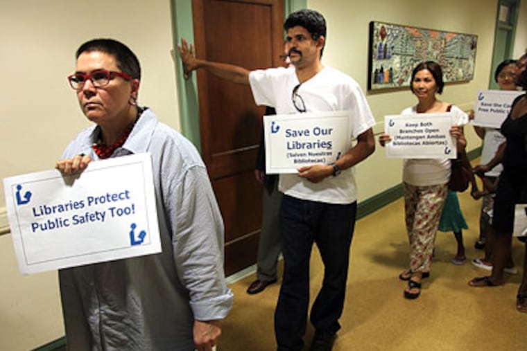 Robin Guenther, left, a children's librarian at Camden's main library, and Frankie Matos, center, file in to Camden City Council to protest Mayor Dana Redd's proposed budget on Tuesday. (Laurence Kesterson / Staff Photographer)