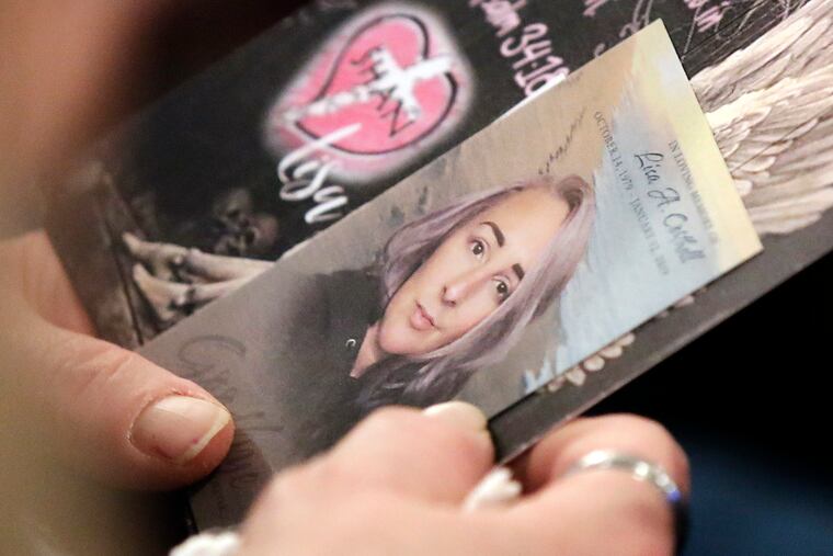 Charlene Burmylo holds Lisa Corthell's mass card during a memorial service Sunday at Boucher Funeral Home in Deptford, N.J. Corthell, 39, died Jan. 12. She had been clean and sober for more than 5 years and had touched the lives of countless women, most of them heroin addicts and prostitutes on the streets of Camden.