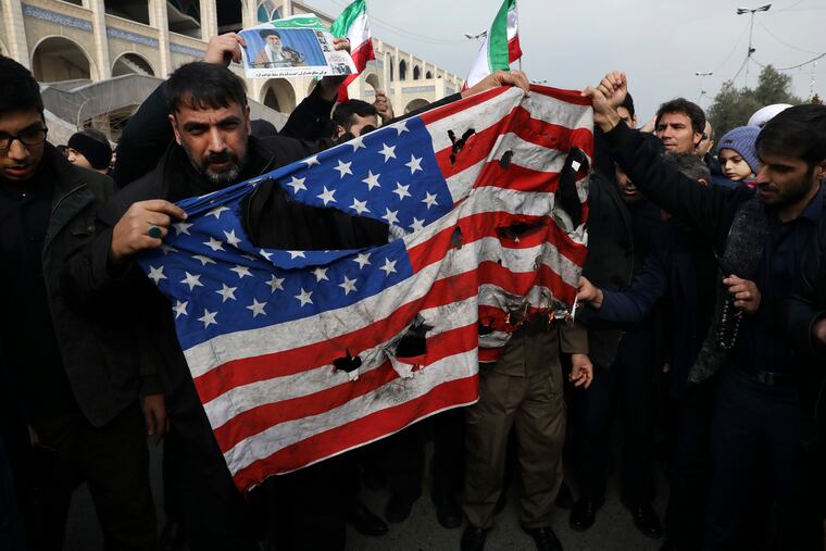 Protesters burn a U.S. flag Friday during a demonstration over the U.S. air strike in Iraq that killed Iranian Revolutionary Guard Gen. Qassem Soleimani, in Tehran.