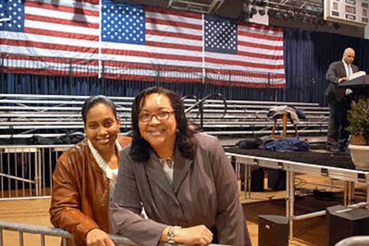Leslie Banks (right) and her daughter, Helena, in the Arcadia University venue where Banks introduced the president. She was invited to make the introduction after e-mailing Obama about her soaring health-insurance premiums. (Tom Gralish / Staff)