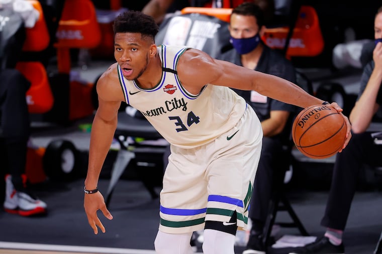Milwaukee Bucks' Giannis Antetokounmpo looks to move the ball against the Houston Rockets during an NBA basketball game Sunday, Aug. 2, 2020, in Lake Buena Vista, Fla.