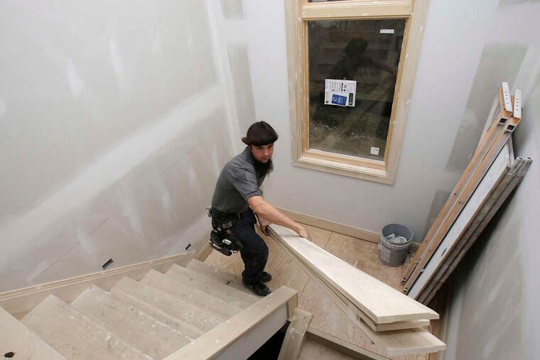 A carpenter works on a new house in the Cleveland suburb of Pepper Pike. Some weakening of demand was seen.