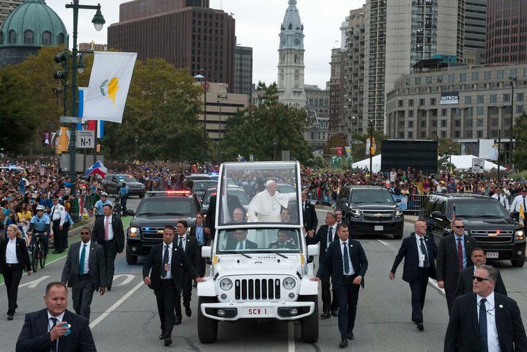 Pope Francis waves to the faithful as he travels up the Parkway in his popemobile. Sunday's ceremony in front of the Philadelphia Museum of Art was the grand finale of the pontiff's historic first visit to the United States.