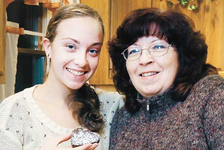 Lillie Gilligan of West Deptford with her daughter Morgan, 18, and a brownie. ( Steven M. Falk / Staff Photographer )