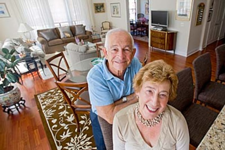 Arthur and Rebecca Silver in their Naval Square condo. The couple, who spent almost four decades in Cherry Hill, considered moving to New York before deciding to buy in Philadelphia. (CLEM MURRAY / Staff)