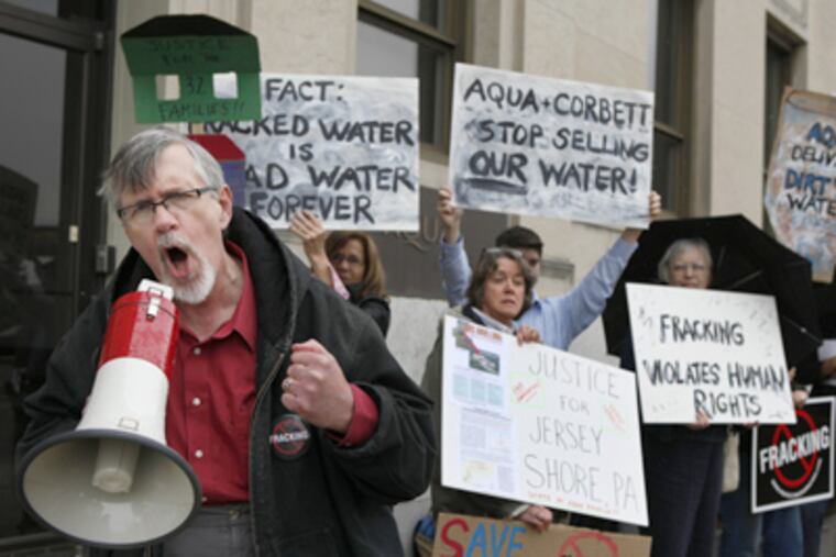 Nathan Sooy, Pa. coordinator for Clean Water Action, speaks at a protest in front of Aqua America headquarters in Bryn Mawr. (Michael S. Wirtz / Staff Photographer)
