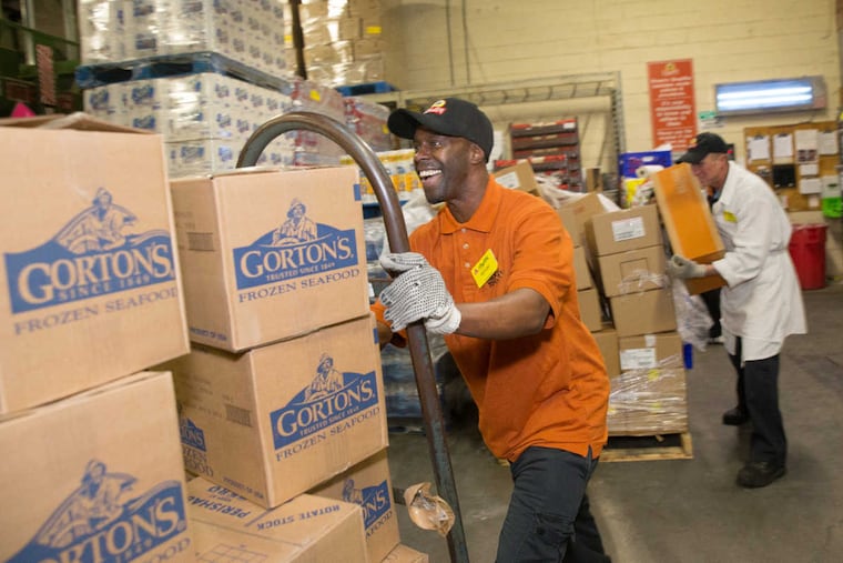 Anthony Jackson, frozen food manager at the Roxborough ShopRite, transports boxes of frozen food at the store, Wednesday, Feb. 22, 2017, in Philadelphia. Jackson is a long-term employee at the store; he formerly served time in prison.