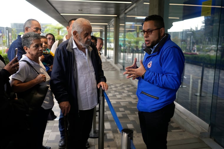 A U.S. consular official explains to people with scheduled visa document submissions that their appointments were canceled due to Colombian President Gustavo Petro's refusal to accept repatriation flights of Colombian citizens from the U.S., at a U.S. Embassy Applicant Service Center in Bogota, Colombia, on Monday, Jan. 27, 2025.