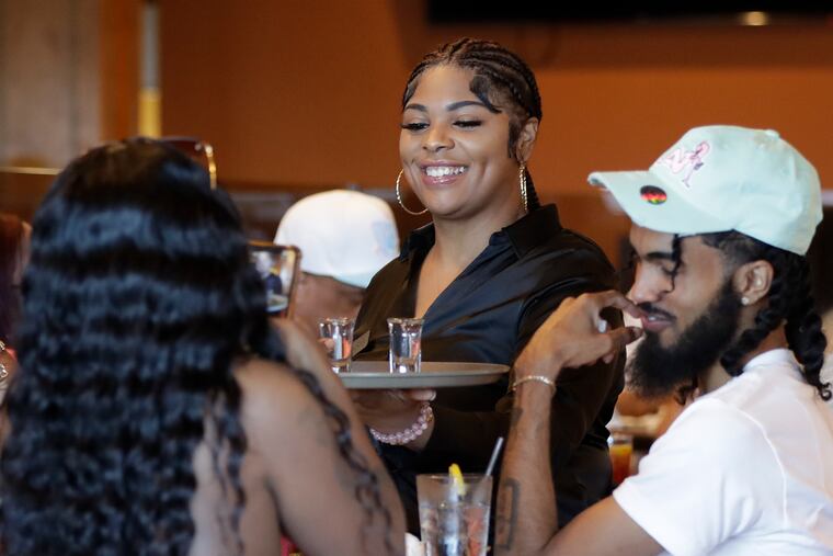Kelsey's server Tanisha Key serves drinks during happy hour in Atlantic City on Thursday, August 18, 2022.