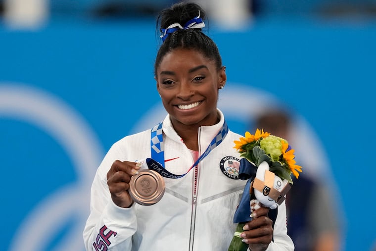 U.S. gymnast Simone Biles poses with her bronze medal for the artistic gymnastics women's balance beam apparatus at the 2020 Summer Olympics in 2021 in Tokyo, Japan.