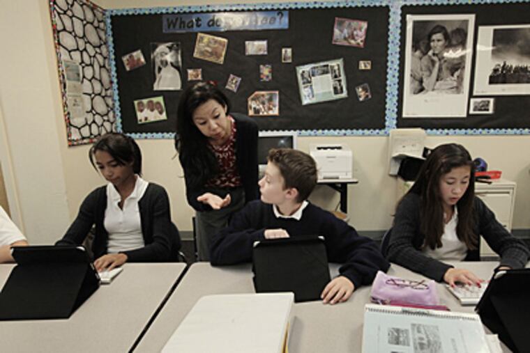 Christina Pak, center left, has her students use iPads during a history lesson at Hillbrook School in Los Gatos, Calif. Also pictured are seventh-grade students Jacqueline Vaughn, from left, Curtis Lloyd and Maya Mizuki. (Gary Reyes/San Jose Mercury News/MCT)