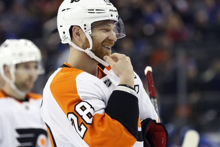 Flyers left winger Claude Giroux (28) laughs after sparring with New York Rangers right winger Mats Zuccarello in a recent game.