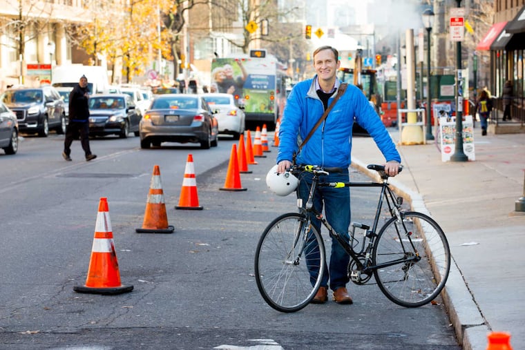 Dave Brindley, with his bike, in the DIY protected bike lane he made with traffic cones.